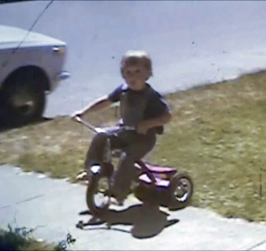 noah on trike in front yard