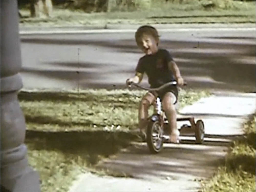 noah on trike in front yard