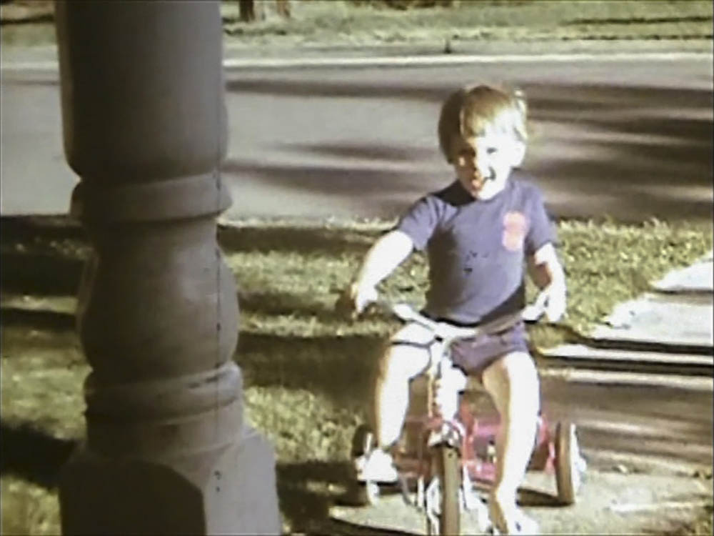 noah on trike in front yard