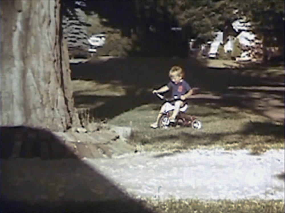 noah on trike in front yard